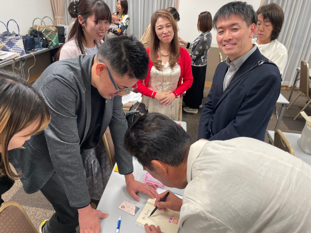 講演会終了後、『想いを形に』の著者にサインを求める参加者
